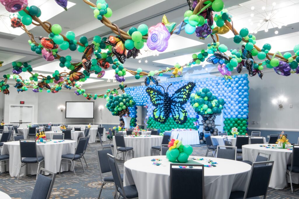 Butterfly balloon wall with floral accents
