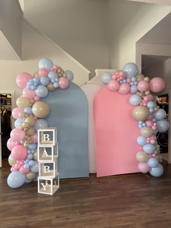 Baby shower balloon decor arranged around a celebration display