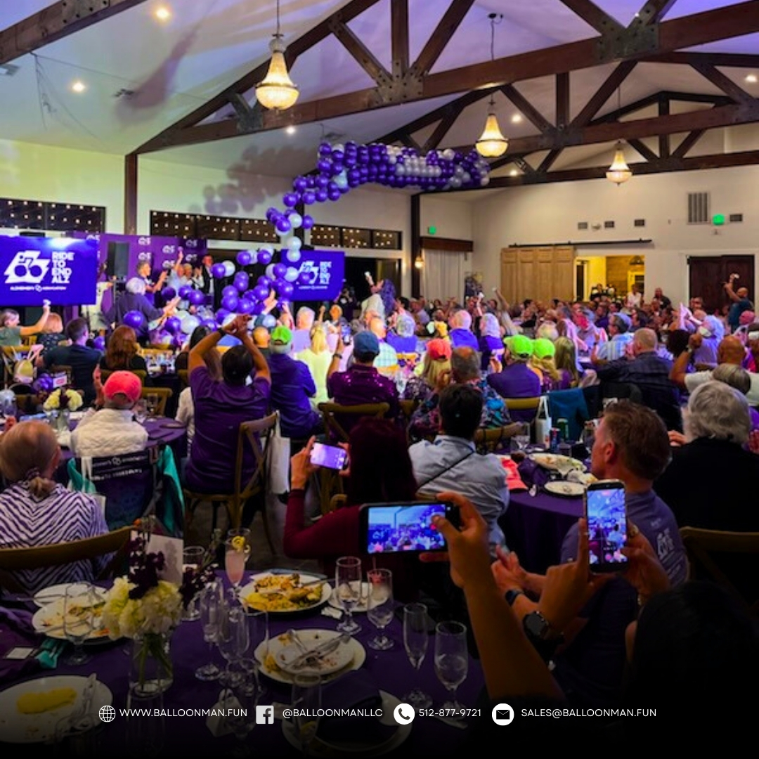 Balloon drop in New Braunfels style celebration with balloons falling over guests