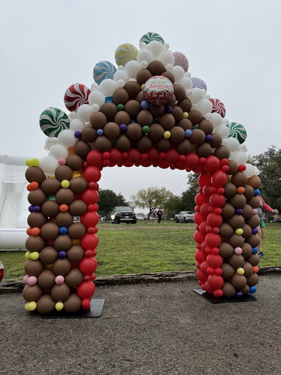 Gingerbread house themed holiday balloon installation