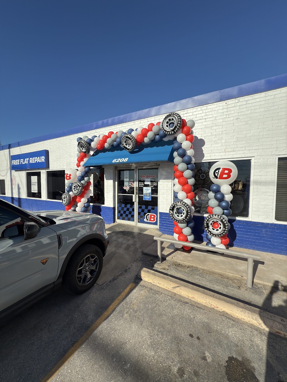 Custom branded balloon arch installed around a business storefront