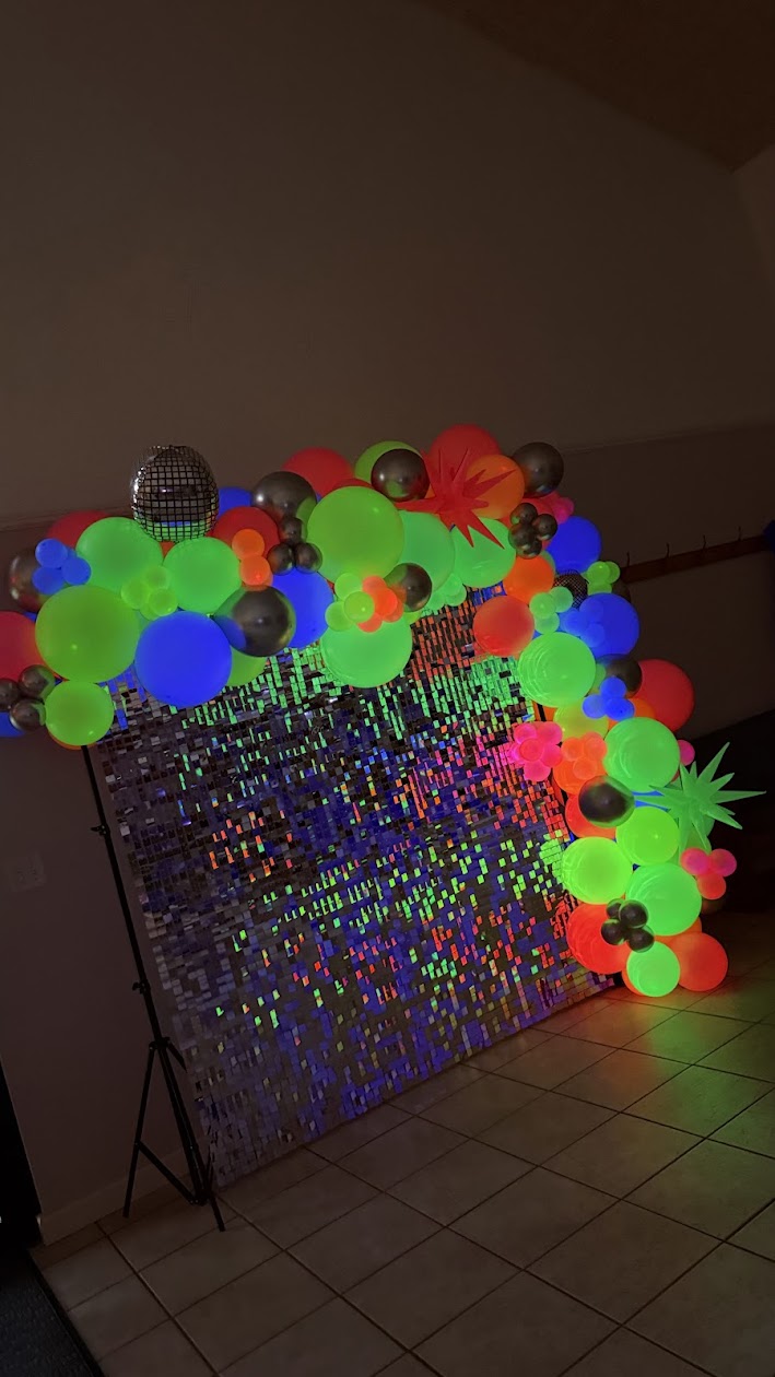 Colorful balloon garland with neon event styling